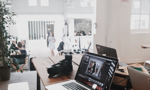 picture of an office space with a open laptop sitting on a wooden counter