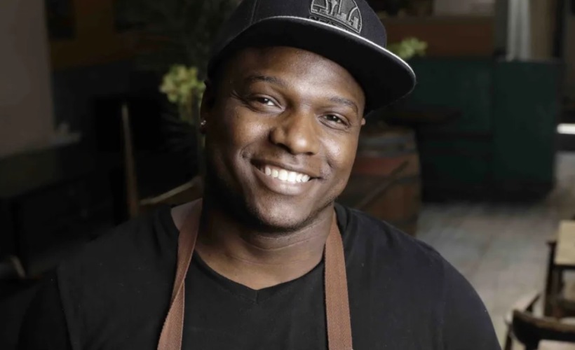 a man in an apron smiling