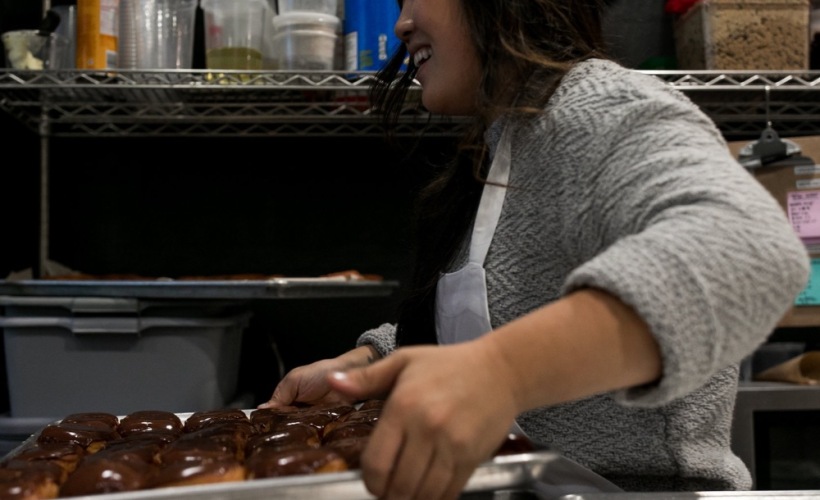 A woman baking doughnuts